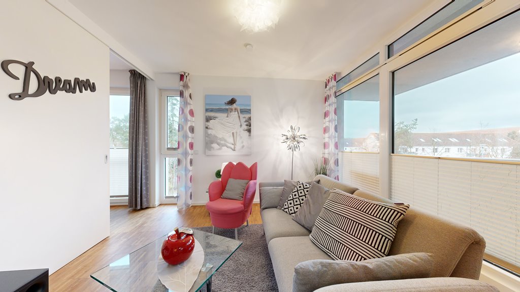 ick vom Wohnbereich auf die offene Küche und davor plazierten Essbereich - DünenResort